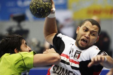 Hassan Yonsry (R) of Egypt is challenged by Chahbour Omar of Algeria during their semi-final match at the 19th Africa Nations Handball Championship in Cairo Stadium