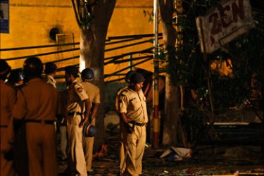 r_Police personnel examine the site of a bomb blast at the German Bakery restaurant in Pune February 14, 2010. The bomb ripped through the packed restaurant