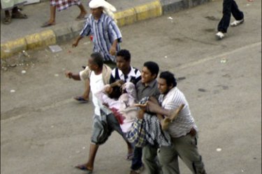 r : People carry a wounded protester after clashes between police and supporters of separatist groups in the southern Yemeni city of al-Houta February 13, 2010. Secessionist