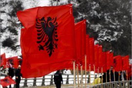 People are seen amidst Albanian flags lining a bridge in the town of Kacanik on February 16, 2010, in preparation for the second anniversary of Kosovo's declaration of independence. On February 17, Kosovo will mark the second anniversary of its unilateral declaration of independence from Serbia.