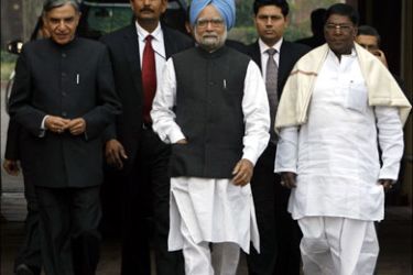 r ; India's Prime Minister Manmohan Singh (C) arrives at the parliament building accompanied by Parliamentary Affairs Minister Pawan Kumar Bansal (L) and Junior Parliamentary