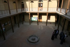 Men and women stand in the courtyard of the historic "Beit al-Oud" (Luth House) music school in Baghdad