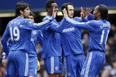Chelsea's Ivorian striker Didier Drogba (R) celebrates with team-mates after scoring the opening goal of the FA Cup fifth round football match between Chelsea and Cardiff City