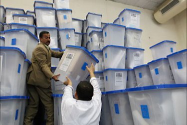 r_An employee of the Independent High Electoral Commission (IHEC) aligns boxes containing the special parliamentary ballots, at a counting centre in Baghdad March 8, 2010
