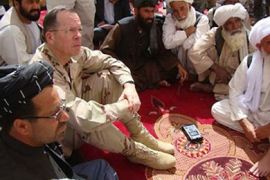 epa02098852 Chairman, Joint Chiefs of Staff, US Adm. Mike Mullen (2-L) and governor of Helmand province Golab Mangal (L), talk with Afghan elders, during their meeting in Marjah district of volatile Helmand province, Afghanistan on 30 March 2010