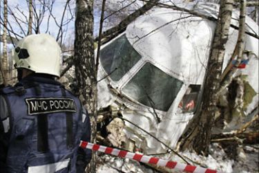 r_A rescue worker stands near the cockpit of the crashed Russian Tupolev TU-204 plane near Moscow's Domodedovo airport March 22, 2010.