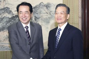 Japan's Finance Minister Naoto Kan (L) shakes hands with Chinese Premier Wen Jiabao before their meeting in Beijing
