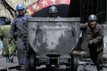 Rescue miners pull a tram car out of an entrance of the flooding accident of Wangjialing Coal Mine, located across both Xiangning county and Hejin city, in northern China's Shanxi province April 1, 2010.