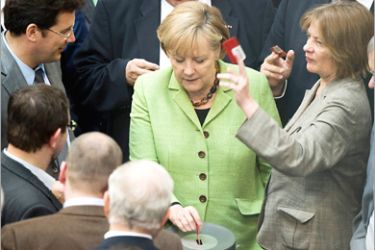 AFP- German parliamentarians including Chancellor Angela Merkel vote after a debate at the Bundestag, the lower house of parliament, on May 21, 2010 in Berlin. Parliament's lower