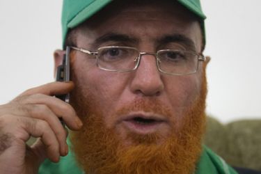 Senior Hamas leader Mohammed Abu Teir, 58, talks on the phone as he is welcomed by family and friends following his release from an Israeli jail on May 20, 2010 in the east Jerusalem district of Sur Baher.
