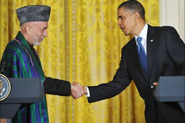 f_Afghan President Hamid Karzai shakes hands with US President Barack Obama during a press conference May 12, 2010 in the East Room of the White House in Washington