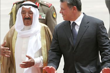f_Jordan's King Abdullah (R) welcomes Kuwait's Emir Sheikh Sabah al-Ahmad al-Sabah upon his arrival at Amman airport May 17, 2010.