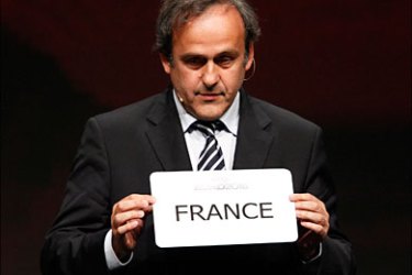 r_UEFA President Michel Platini holds a card with the name of France, chosen as the country to host the European soccer championships in 2016 during an announcement ceremony