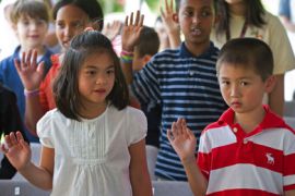 Grace Tuong An Tran (L) and Thinh Nhat Vo, both from Viet Nam, are sworn-in as US citizens along with 23 other children ages