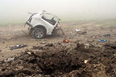 A burnt out automobile and crater are seen on a road outside the village of Sergokalinskoe in Dagestan on May 13, 2010. Eight people were killed on in a bomb attack in Russia's southern region of Dagestan, the latest unrest in the troubled North Caucasus, officials said. AFP