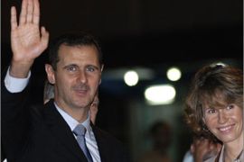 Syrian President, Bashar Al Assad (L), waves alongside his wife Asma al-Assad, upon their arrival at Jose Marti International Airpor in Havana on June 27, 2010. Assad is in Cuba as part of a Latin American tour aimed at consolidating ties, which already took him to