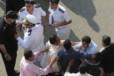 Protestors scuffle with police during a demonstration in downtown Cairo near the Interior Ministry June 13, 2010. Egyptian opposition groups scuffled with security forces