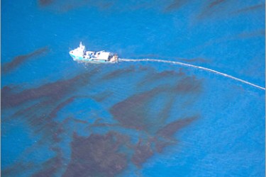AFP - This aerial view released by Greenpeace on June 26, 2010 shows a ship dragging a surface boom through surface oil near the site of the Deepwater Horizon accident, off the Louisiana coast, in the Gulf of Mexico on June 24, 2010.