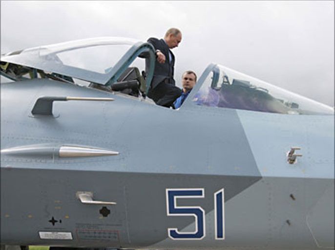 f_Russian Prime Minister Vladimir Putin (L) listens to test pilot Sergei Bogdan as he inspects a new Russian fighter Jet Sukhoi T-50, after its test flight, in Zhukovksy, outside Moscow on June