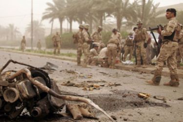 Iraqi troops inspect the scene of a car bomb explosion in Baghdad's Mansur district on June 7, 2010 in which one person was killed and several others were wounded.