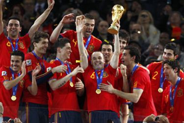Spain's Andres Iniesta holds the World Cup trophy after the 2010 World Cup final soccer match between Netherlands and Spain at Soccer City stadium in Johannesburg July 11, 2010. REUTERS