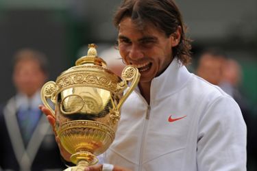 Spain's Rafael Nadal holds the Wimbledon Trophy after beating Czech Republic's Tomas Berdych 6-3, 7-5, 6-4, in the Men's Singles Final at the Wimbledon Tennis