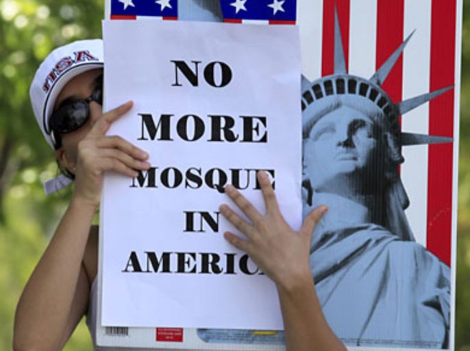 r_A local citizen protests across the street from a business warehouse where the Islamic Center of Temecula Valley currently hold their services in Temlecula, California July 30