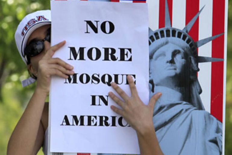 r_A local citizen protests across the street from a business warehouse where the Islamic Center of Temecula Valley currently hold their services in Temlecula, California July 30