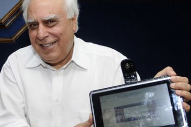Indian Minister for Human Resource Development Kapil Sibal unveils 'laptop' computer device in New Delhi on July 22, 2010.