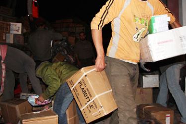 مواطنون يساعدون في إفراغ شحنة أدوية إبان الحرب على غزة في خانيونس