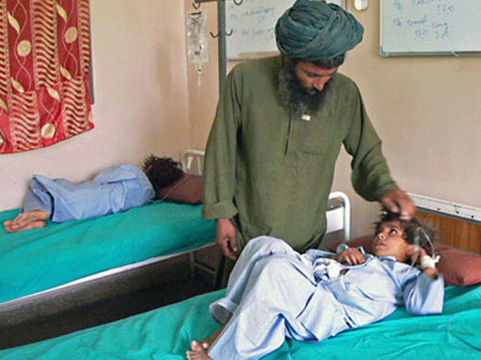 An Afghan man talks to his wounded child at a hospital in southern Kandahar city on July 24, 2010. Afghan President Hamid Karzai has ordered an investigation into the deaths of "a number" of civilians in a rocket attack in southern Afghanistan, his spokesman told AFP on July 26. The rocket attack took place on a village in the Sangin area of Helmand province on July 23.