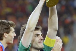 Spain's goalkeeper Iker Casillas holds the World Cup trophy at the end of the 2010 World Cup football final between the Netherlands and Spain on July 11, 2010 at Soccer City