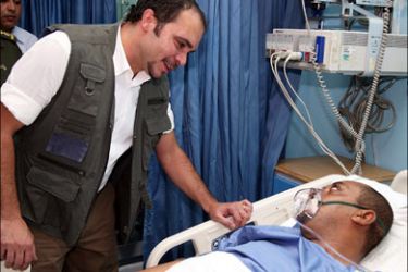 afp : A handout picture from the Jordanian Royal Palace shows Prince Ali bin al-Hussein, half brother of King Abdullah II, visiting a man who was wounded when a Grad-type rocket