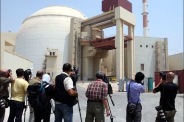 afp : Photographers and cameramen take pictures of the reactor building at the Russian-built Bushehr nuclear power plant in southern Iran on August 21, 2010 during a ceremony initiating