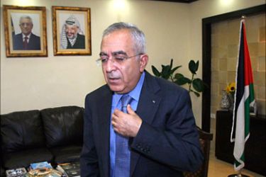 r_Palestinian Prime Minister Salam Fayyad stands in his office after an interview with Reuters in the West Bank city of Ramallah, August 31, 2010