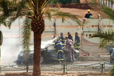 Jordanian police put out a fire after a Grad-type rocket smashed into a street in Jordan's port of Aqaba on August 2, 2010, killing a taxi driver and wounding five other Jordanians, in what the government described as a "terrorist" attack.