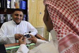 A Saudi man inspects a BlackBerry at a mobile shop in the Saudi Red Sea port city of Jeddah on August 3, 2010 following a decision by the kingdom's regulatory authority to suspend key BlackBerry services