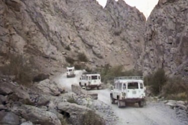 Land Rovers with International Assistance Mission (IAM) personnel aboard travel down a road in an unidentified region of Afghanistan, in this undated image provided by David L.