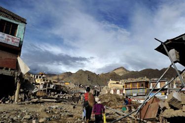 : Local residents walk amidst rubble in Leh on August 8, 2010. Emergency teams in India's remote Himalayan region of Ladakh on August 8 struggled to deliver food and aid to survivors of flash floods that killed more than 130 people and left hundreds missing. A cloudburst