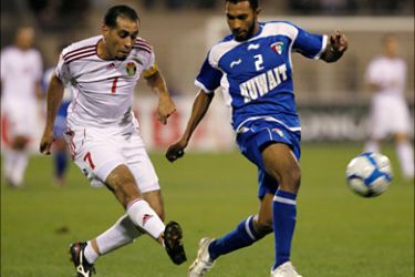 r_Kuwait's Amer Al Fadhel fights for the ball with Jordan's Amer Khalil during their West Asian Football Federation (WAFF) Championship soccer match at King Abdullah Stadium