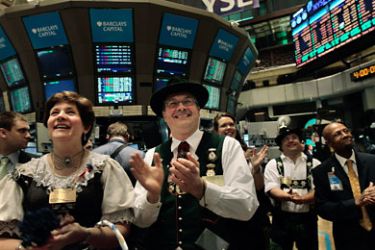 Cornelia Rom (L) and her husband Richard Rom (center) applaud the closing bell on the floor of the New York Stock Exchange September 1, 2010 in New York City. German-Americans were touring at the NYSE to promote an upcoming German-American parade and Oktoberfest in New York. Markets rebounded 3 percent to open the month of September, as positive manufacturing data buoyed major stock indices.
