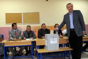 Turkish Prime Minister Tayyip Erdogan (R) casts his vote at a polling station in Istanbul on September 12, 2010. Turks voted on September 12 whether to adopt highly divisive constitutional changes that would reshape the judiciary and curb army powers, in a major test of confidence in the Islamist-rooted government.