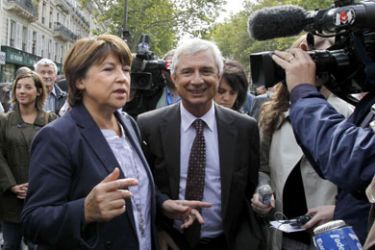 France's opposition Socialist Party (PS) leader Martine Aubry and (PS) Seine Saint-Denis general council President Michel Bartolone (R) arrive to take part to a demonstration on September 7, 2010 in Paris, during a one-day national strike action against a gouvernment pension reform bill.
