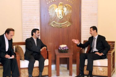 A handout picture released by the official Syrian Arab News Agency (SANA) shows Syria's President Bashar al-Assad (R) during a meeting with his Iranian counterpart Mahmoud Ahmadinejad (C) in the presence of an interpreter in Damascus on September 18, 2010