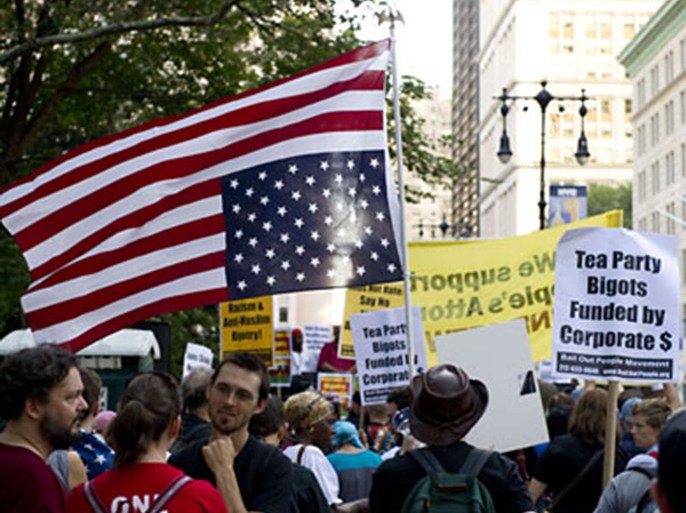 Protesters in support of an Islamic center two blocks from ground zero hold a rally near the New York City Hall ON September 11, 2010. Protesters carried an inverted American flag and anti-racism signs. AFP