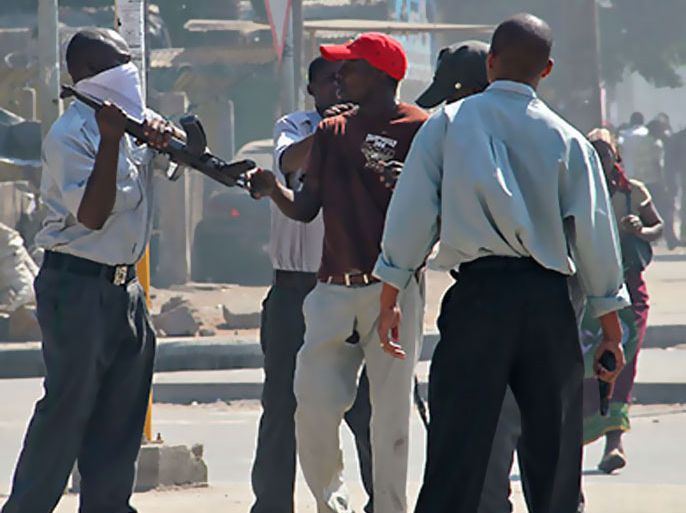 Mozambiquean police beat a protester in a street of Maputo on September 1, 2010. Four people died and dozens were wounded today when police opened fire on demonstrators protesting rising prices in and around the Mozambique capital Maputo. One of the dead was a 12-year-old boy who was shot in the head.