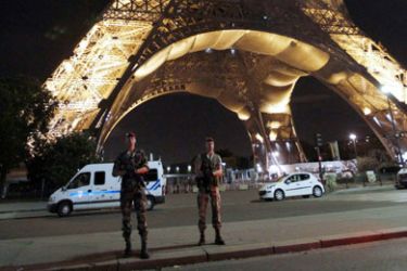 Military officers stand guard after the evacuation of the Eiffel Tower and the park surrounding the Paris landmark following a bomb alert on September 14, 2010. A police officer said about 25,000 people were in the area at the time of the alert but added that they left calmly shortly before 9:00 pm (1900 GMT).