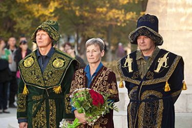 In this image released by NASA, (L-R) Russian Cosmonaut Gennady Padalka, NASA Astronaut Peggy Whitson,and Russian Cosmonaut Valery Korzun, dressed in traditional Kazakh garb, attend a ceremony where they were recognized for their achievements in space flight on September 23, 2010