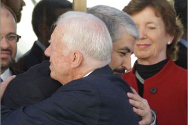 Elders group member Mary Robinson (back-R), Ireland's former president and UN high commissioner for human rights, looks on as fellow member and former US president Jimmy Carter (R), embraces Hamas movement's exiled leader Khaled Meshaal upon their arrival at the latter's office in Damascus for a meeting on October 19, 2010 on the third leg of the Elders' Middle East tour which has