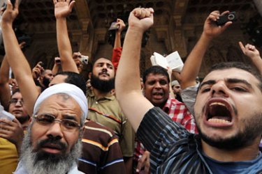 EGYPT : Egyptian Muslims shout slogans during a demonstration against Christian Copts following Friday noon prayers in downtown Cairo, on October 1, 2010. The head of Egypt's Coptic Orthodox Church said last week he regretted the fact that Muslims were offended by the comments of a senior bishop who cast doubt on the authenticity of some verses in the Koran. AFP